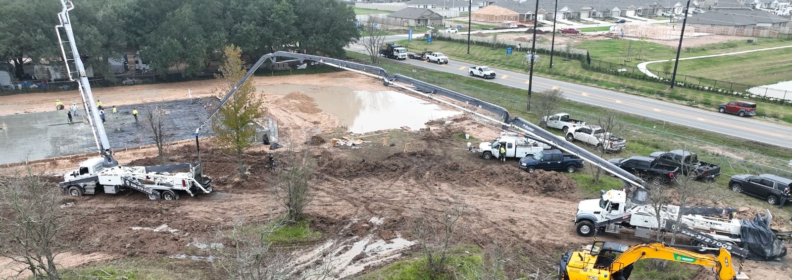 Aerial view of a boom pump and line on a jobsite